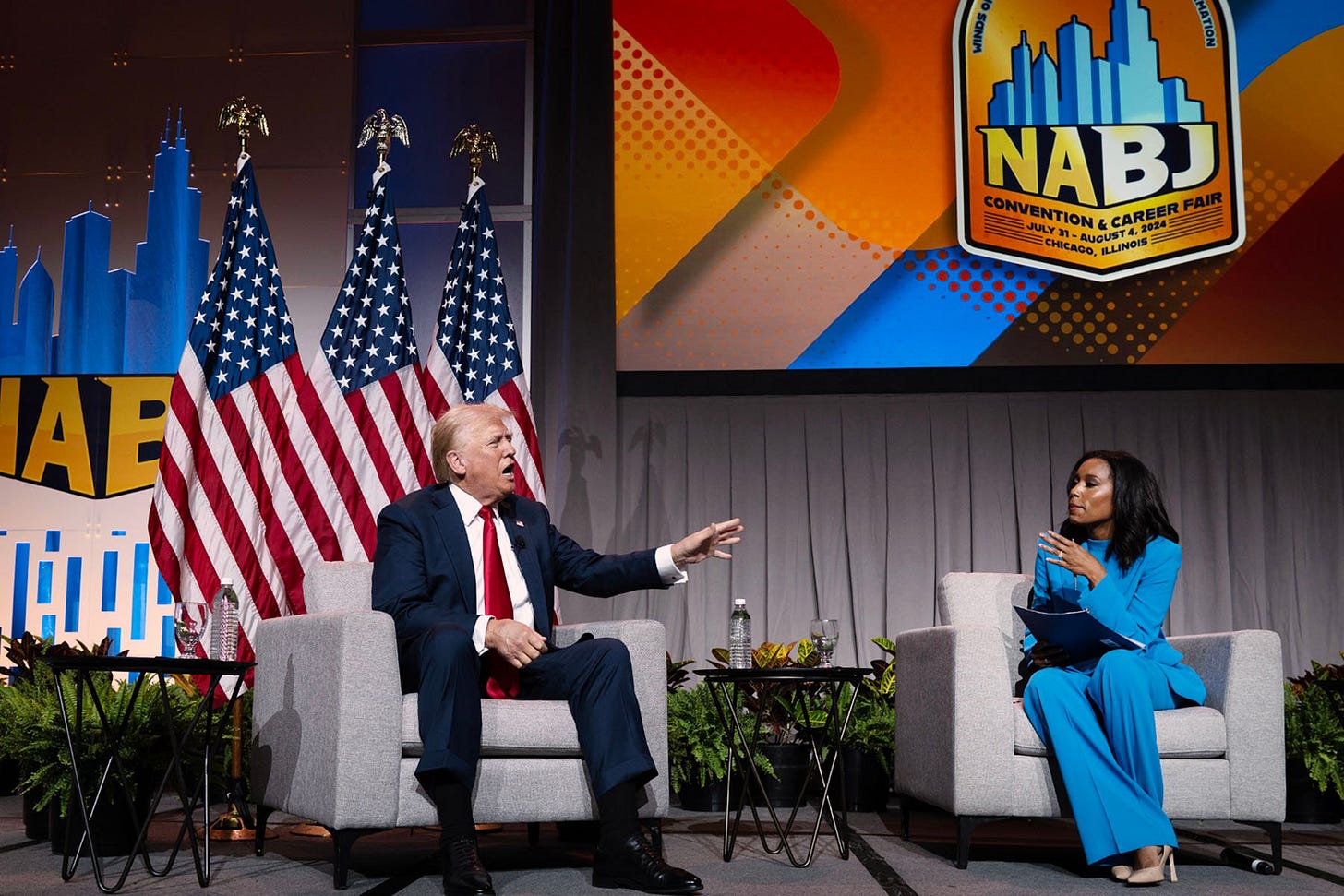 Former President Donald Trump speaks with ABC journalist Rachel Scott on stage at the National Association of Black Journalists convention's yearly convention.
