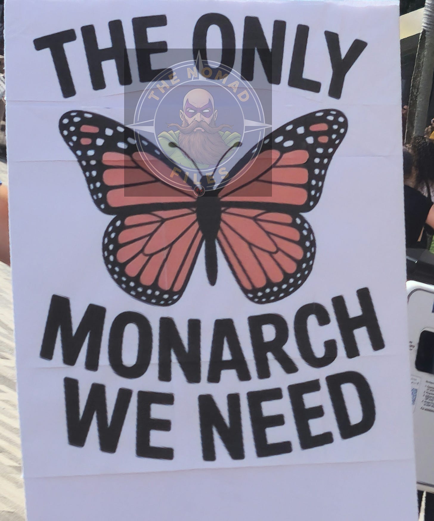 A white sign featuring a large monarch butterfly with the text "THE ONLY MONARCH WE NEED."