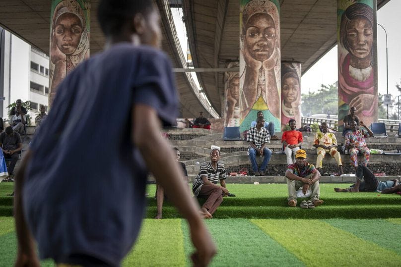 A teammate shouts out as youth play football underneath a highway bridge on Ikoyi Island, Lagos, February 2023 A teammate shouts out as youth play football underneath a highway bridge on Ikoyi Island, Lagos, February 2023