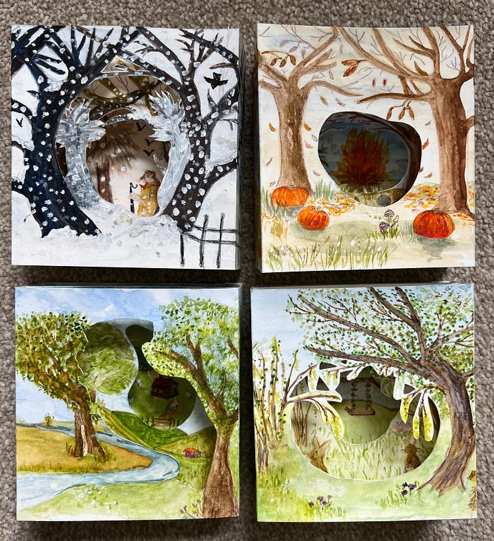 A collection of paper tunnel books handmade depicting the four season illustrated in watercolour and ink