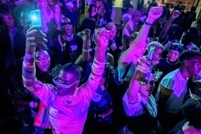 People dance by the stage of The Nest club during the Vogue Nights Jozi Ball, an event dedicated to the gender-fluid culture in Marshalltown, Johannesburg on September 24, 2022.