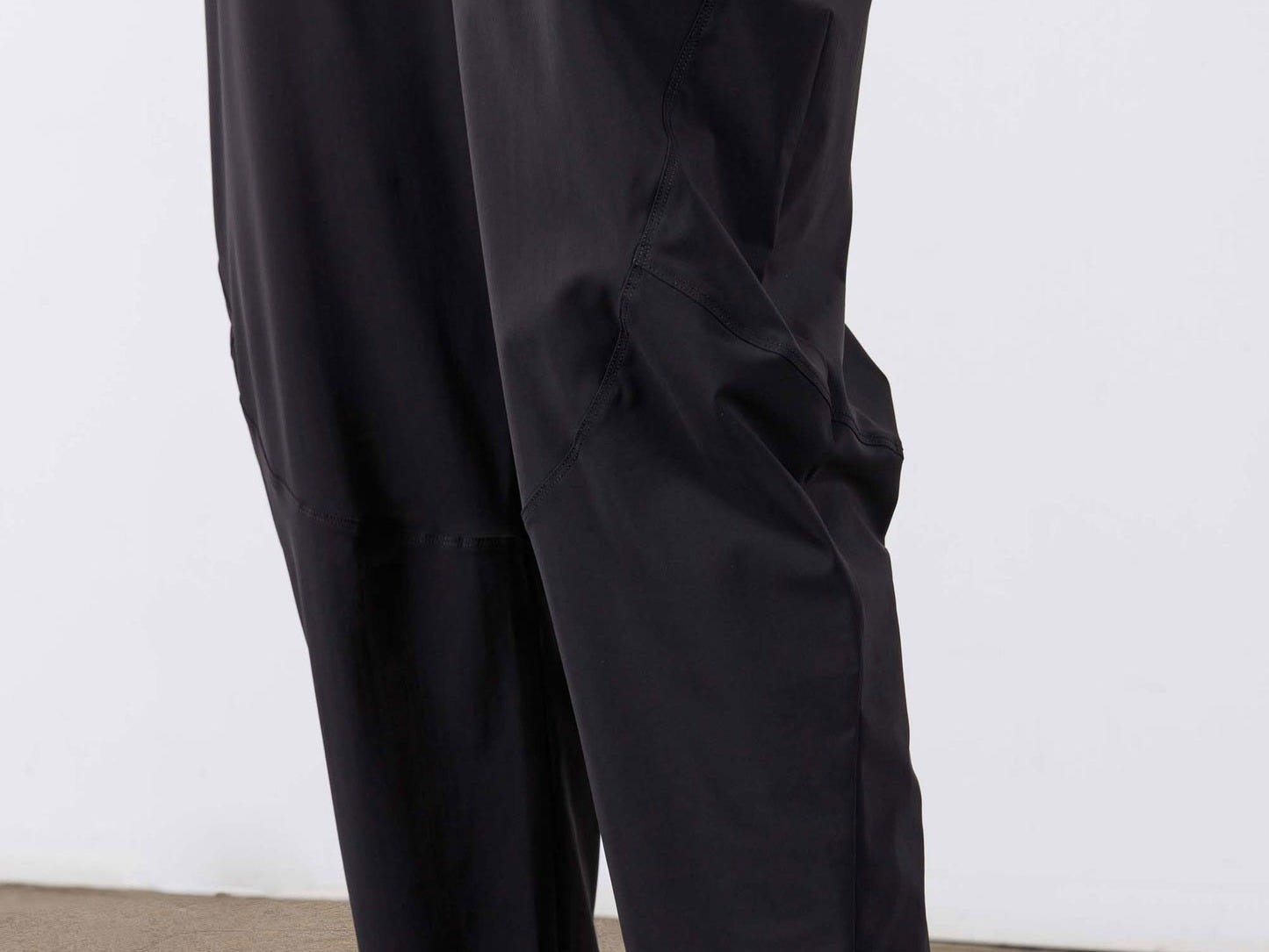 Black cropped wide-leg pants with stitched seams and cuffed hem