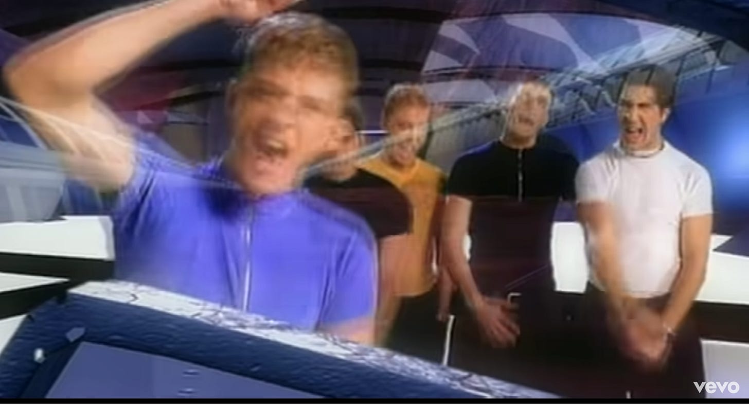 Same image of Justin in front against the glass, but this time he's pounding his fist and all the boys are yelling