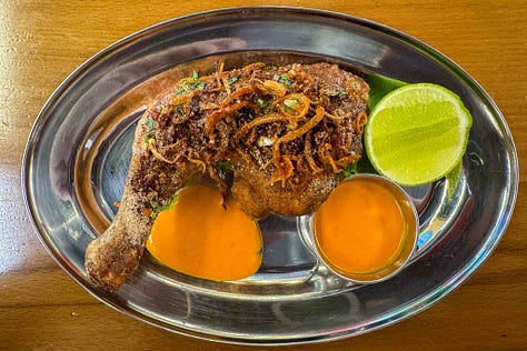Al Naqa's Lao Tahini Caesar's Salad and the Special Hay Yai Dubai Fried Chicken Quarter Leg. A message to AJ, written by hand.