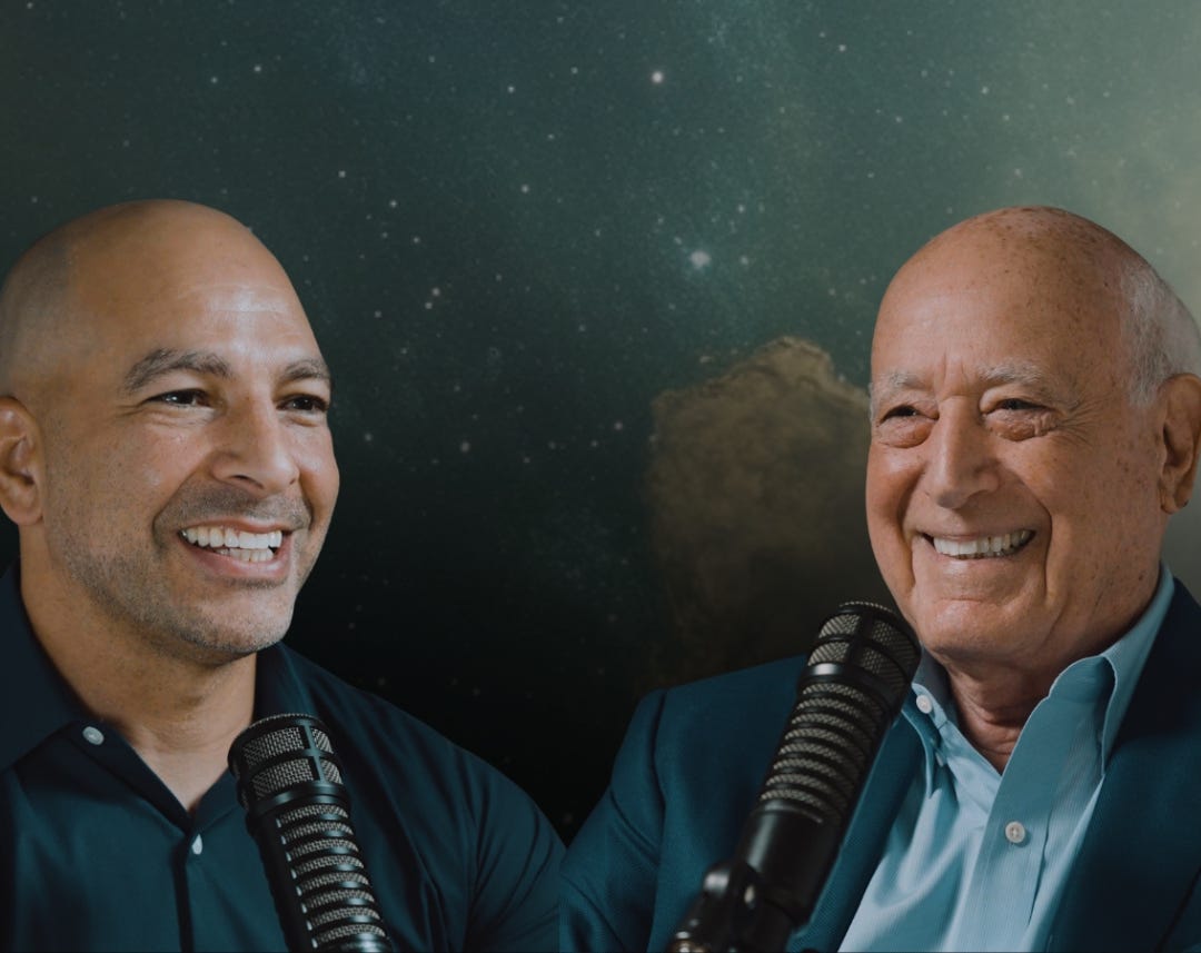 A couple of men smiling and holding microphones

AI-generated content may be incorrect.