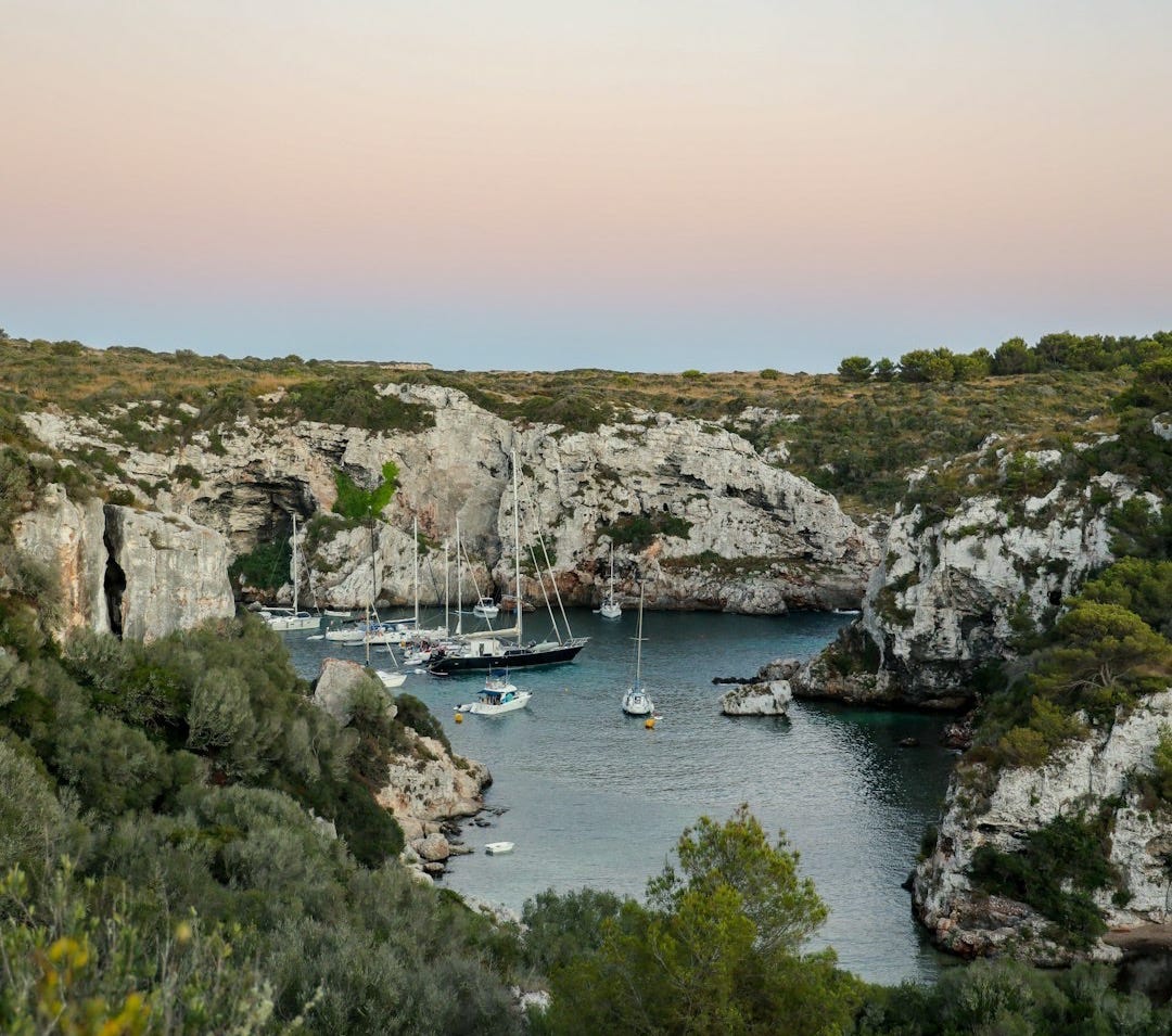 boats sitting in the water in menorca holiday