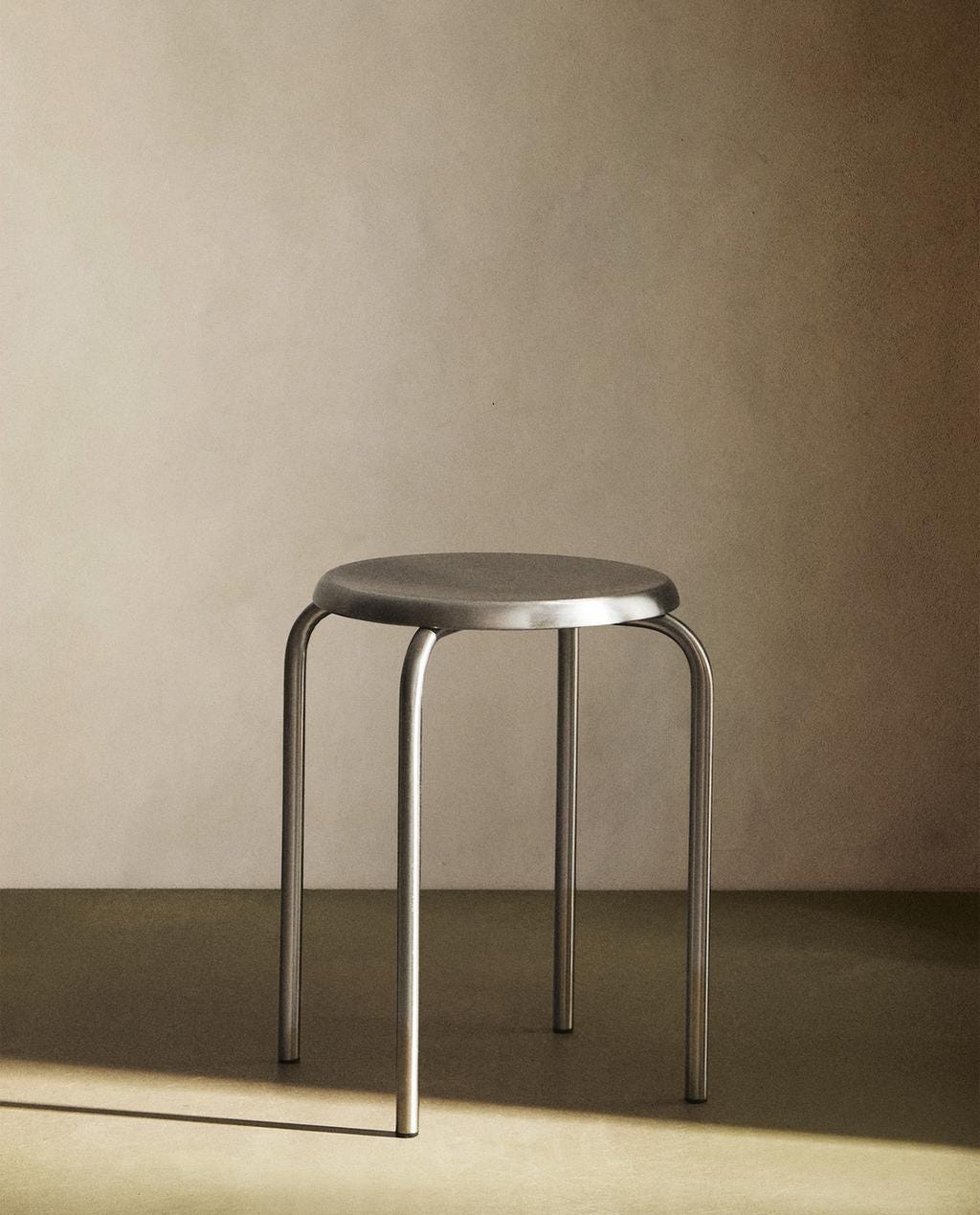 Metal chair with a round seat and tubular legs. Metal chair with a round seat and tubular legs.