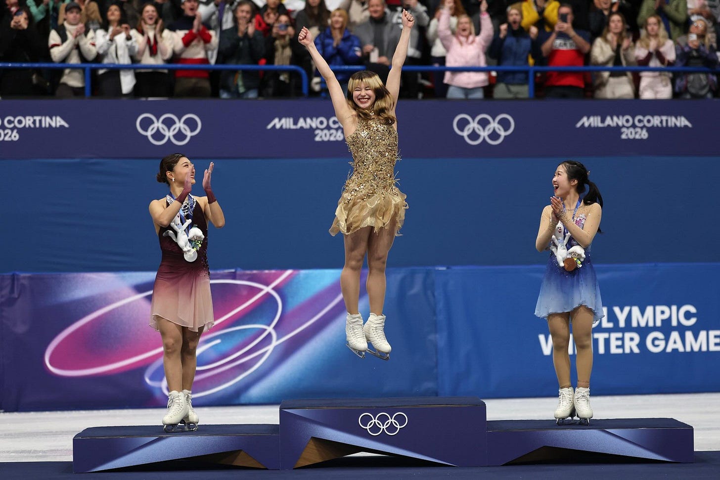 May be an image of skates and text that says 'CORTINA 26 MILANOC 2026 MILANO MIL MILANOCORTINA CORTINA 2026 LYMPIC TER GAME'