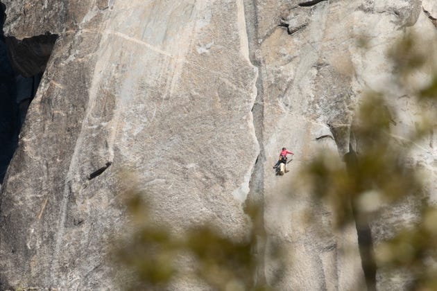 Man Rock Climbing the Granite Wall Man Rock Climbing the Granite Wall