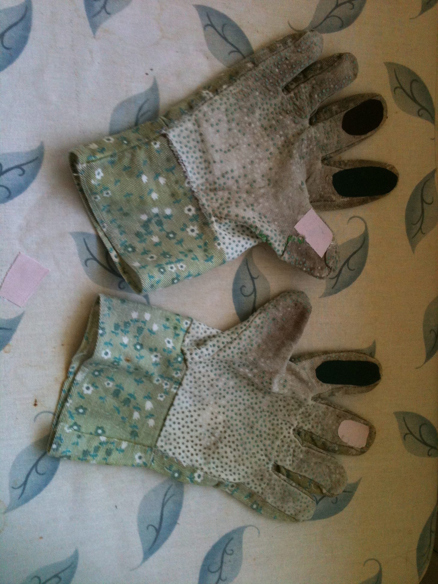 Garden gloves with ironed-on patches over the worn-out fingers.
