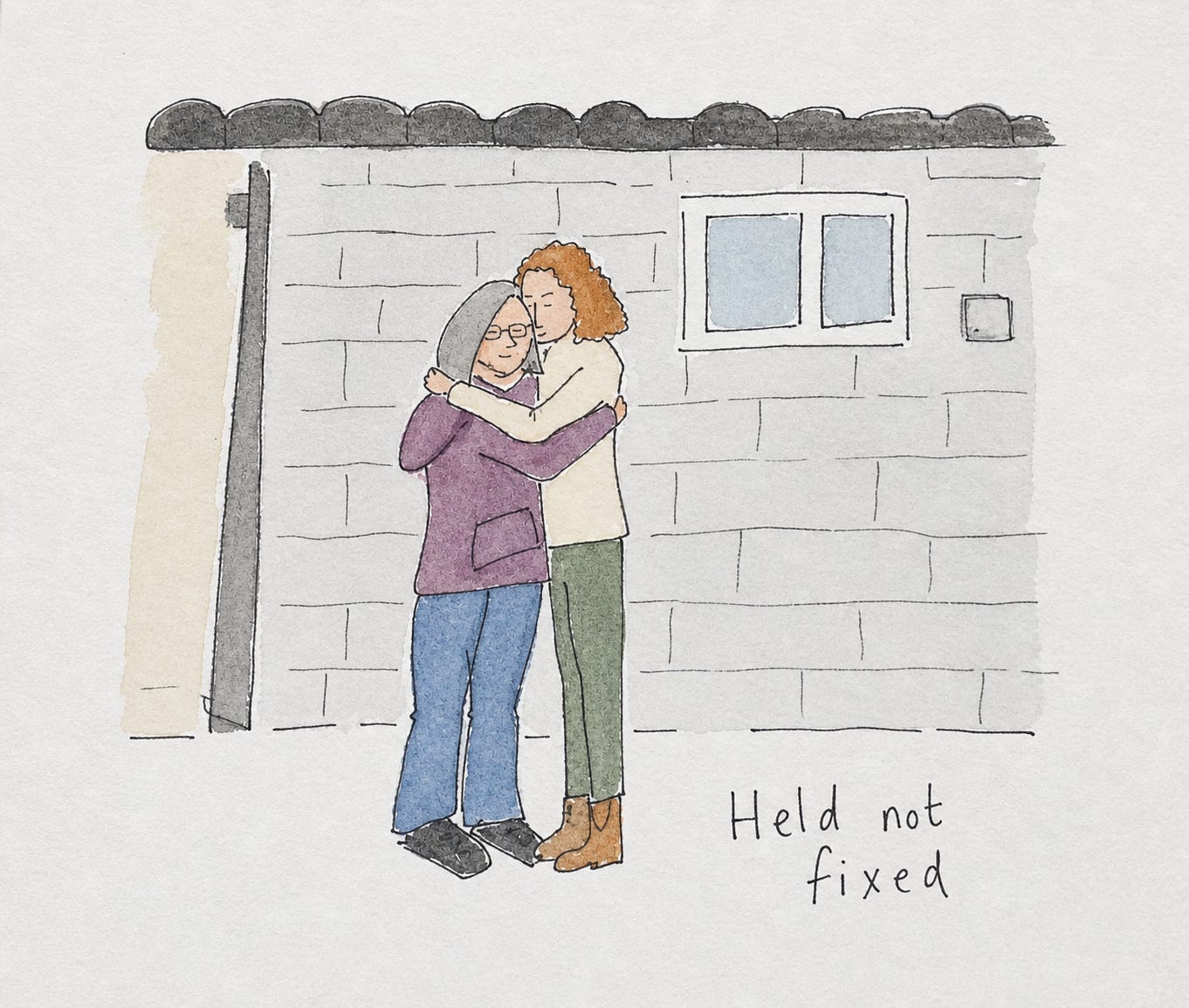 A soft ink and watercolour illustration of two women standing close together and hugging in front of a light grey brick wall. One woman, shorter with grey bobbed hair and glasses, wears a purple hoodie and blue jeans. The taller woman, with curly reddish hair, wears a cream jacket, green trousers, and brown boots, with her arms wrapped gently around the other. A small window is visible in the wall behind them. In the bottom right corner, handwritten in neat ink, are the words “Held not fixed.”