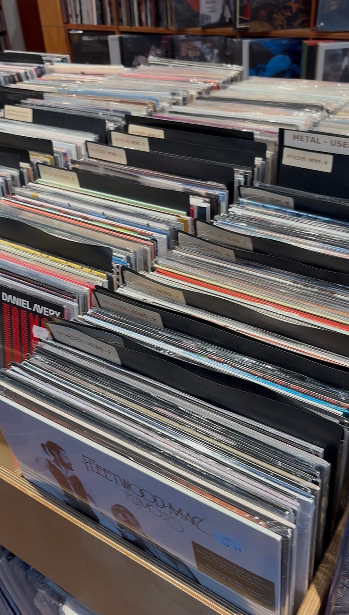 Vinyl records, neon window sign, mirror selfie, a living room with a giant disco ball
