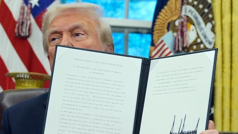 A man sits at a desk and holds up a folder. A man sits at a desk and holds up a folder.