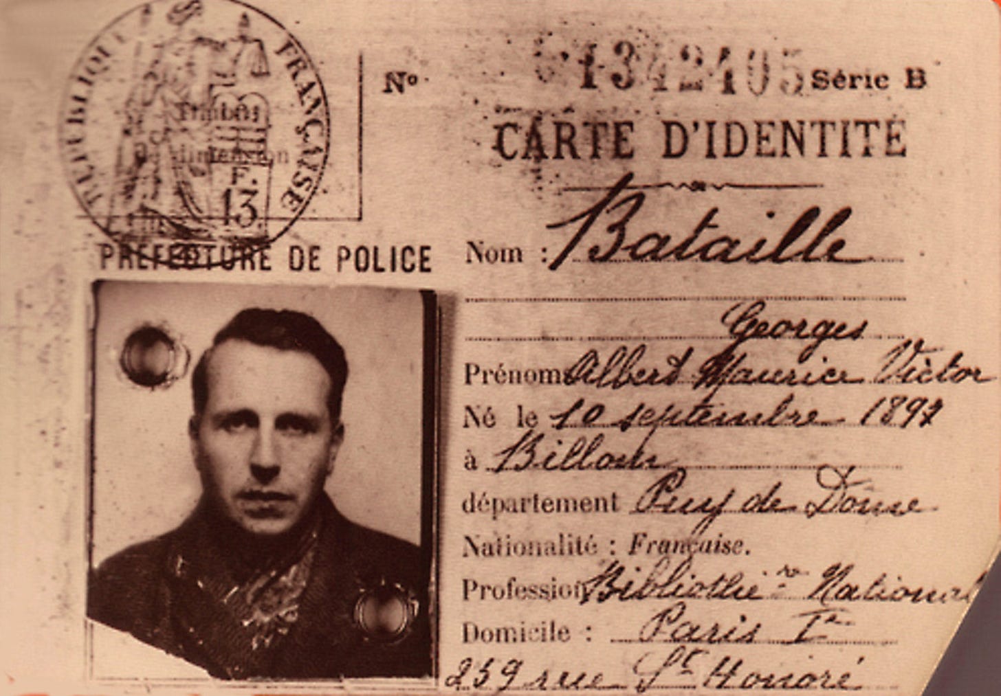 A 1940 identity card with a photo of Georges Bataille on the left and his administrative details on the right A 1940 identity card with a photo of Georges Bataille on the left and his administrative details on the right