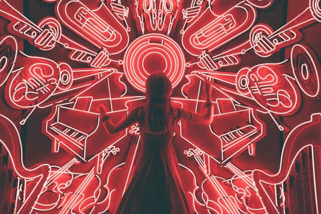 woman standing watching LED light musical instrument photo woman standing watching LED light musical instrument photo