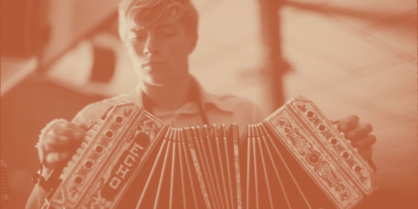 young man playing an accordion