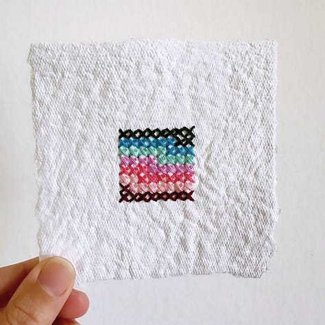 Cross stitch squares on handmade paper