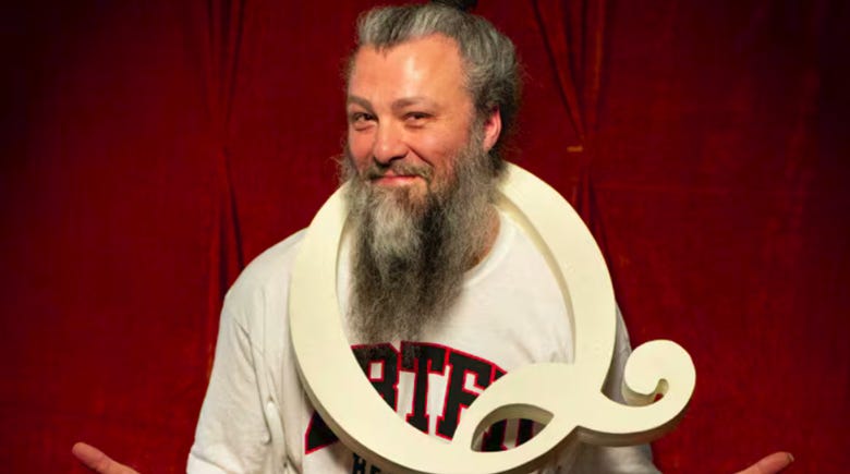 The image shows a person holding a white, twisted, decorative object against a red backdrop.
AI-generated content may be incorrect. The image shows a person holding a white, twisted, decorative object against a red backdrop.
AI-generated content may be incorrect.