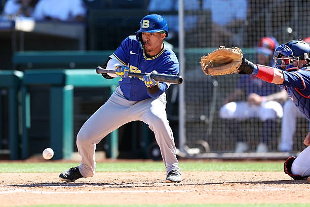 Gabriel MacIel of Team Brazil bunts during the fourth inning of a World Baseball Classic exhibition game against the Texas Rangers at Surprise... Gabriel MacIel of Team Brazil bunts during the fourth inning of a World Baseball Classic exhibition game against the Texas Rangers at Surprise...