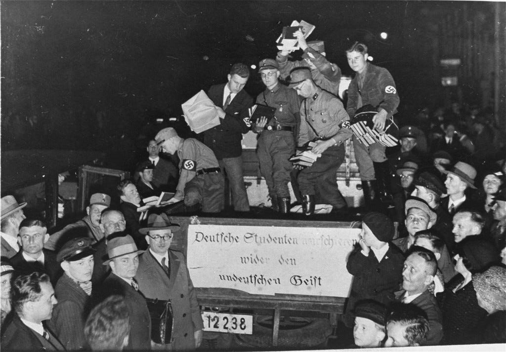 Students and members of the SA unload books deemed "un-German" during the book burning in Berlin. [LCID: 45032]