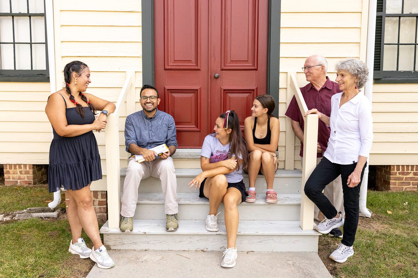 Salaam Bhatti sitting in front of a home in Virginia talking to voters Salaam Bhatti sitting in front of a home in Virginia talking to voters