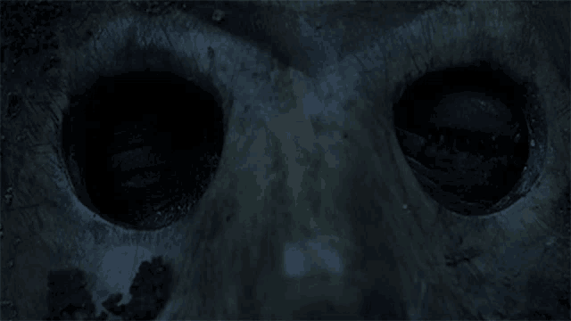 a close up of a person 's face with a dark background