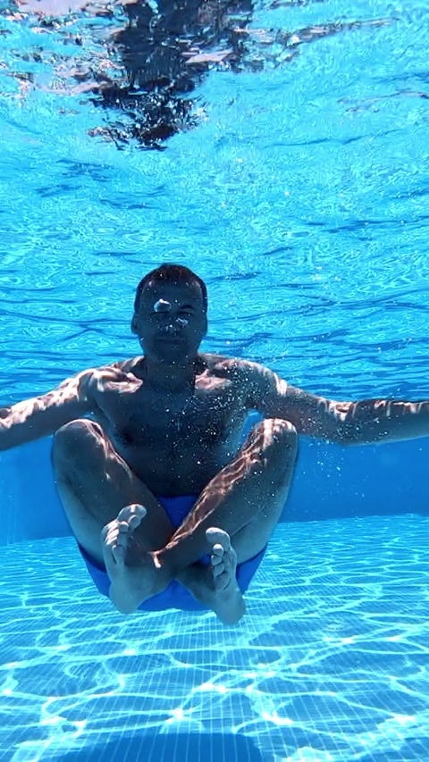 Man sitting underwater in yoga pose. Und... | Stock Video | Pond5