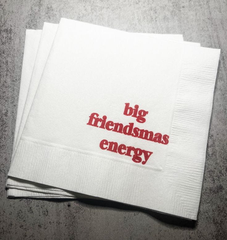 This may contain: two white napkins with the words big friendsmas energy printed on them, sitting next to each other