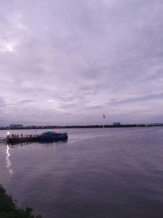 Sky at twilight against a lake with a boat in the middle. Sky at twilight against a lake with a boat in the middle.
