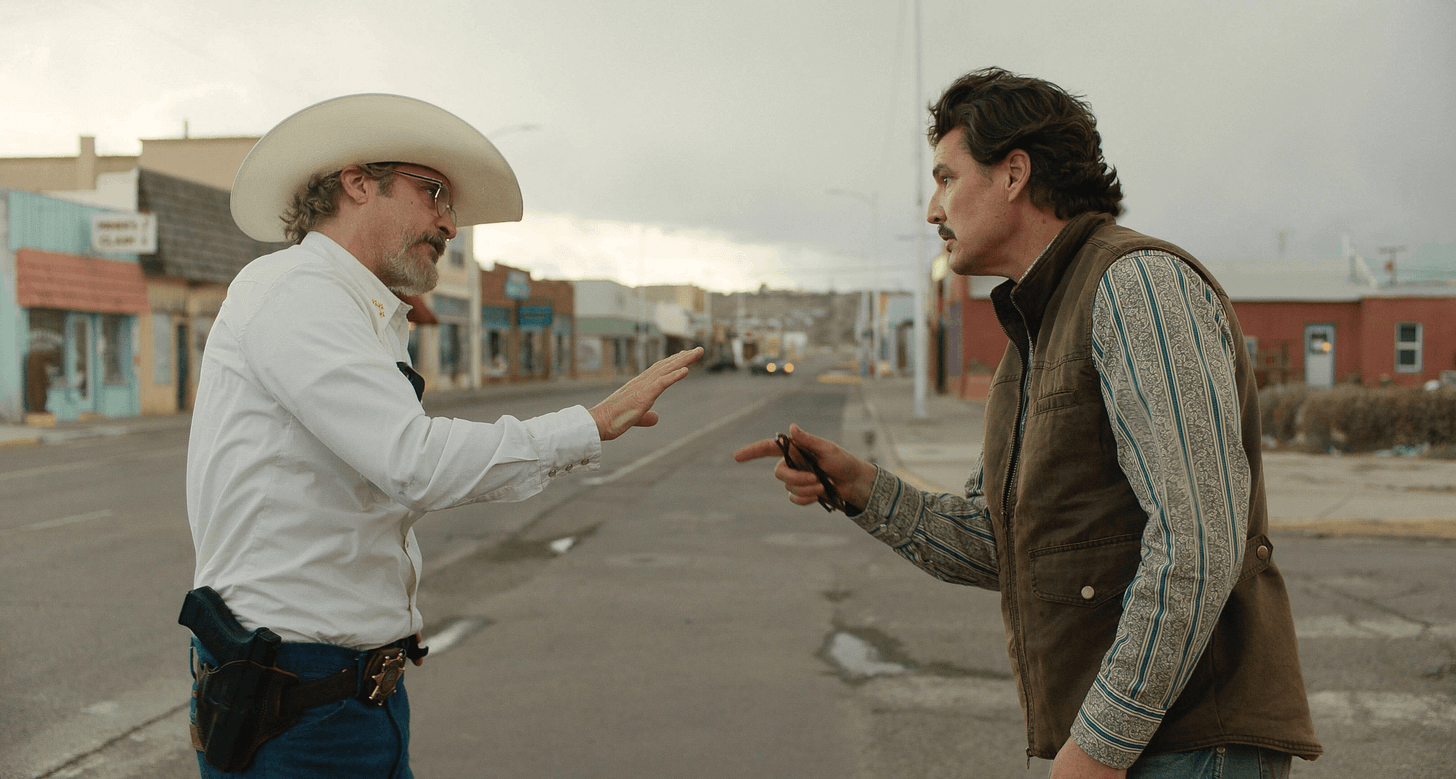 Image may contain Pedro Pascal Joaquin Phoenix Clothing Hat Adult Person Conversation Car and Transportation