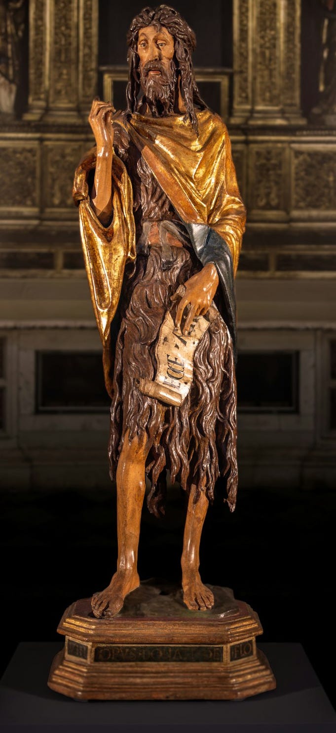 A statue of jesus holding a cross in a church