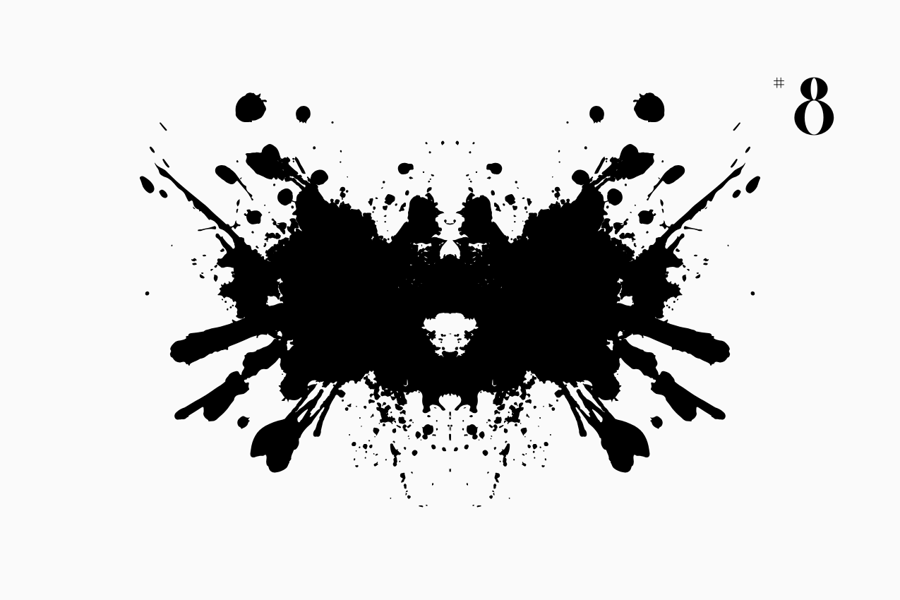 A bilateral, Rorschach-style inkblot specimen for the “In Other Words” series from The Subtext Review. The charcoal-black symmetrical splatter is centered on a cream paper background, labeled as Puzzle No. 8 in a classic serif typeface.