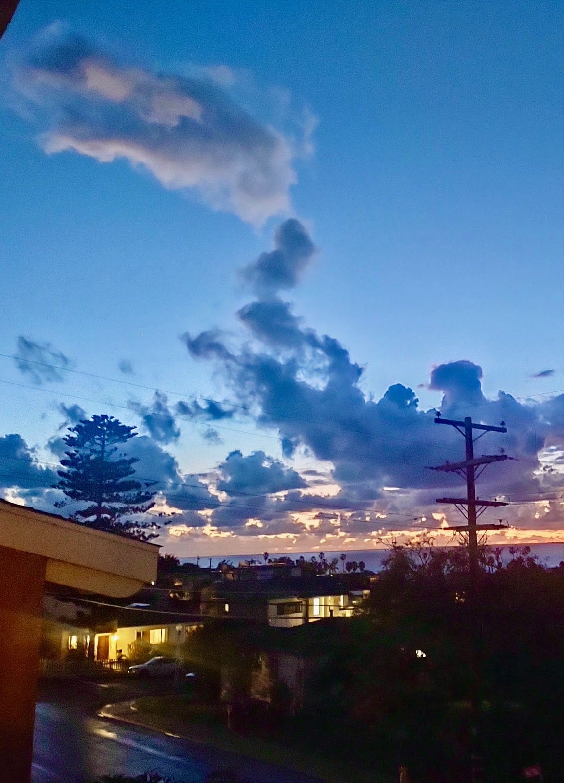 Cloud formation over Pacific ocean at sunset that looks a bit like a dragon rising out of its lair