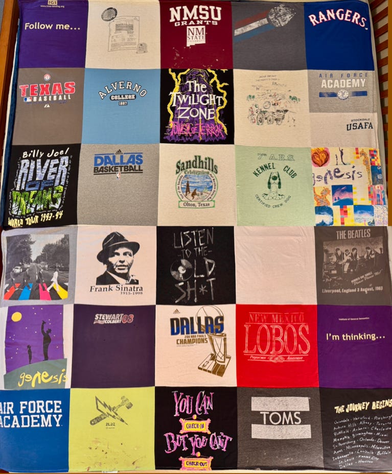photo of large quilt made of 30 squares of old tshirts