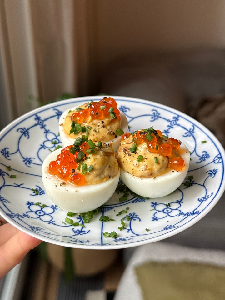 caramelized onion deviled eggs with salmon roe and chives