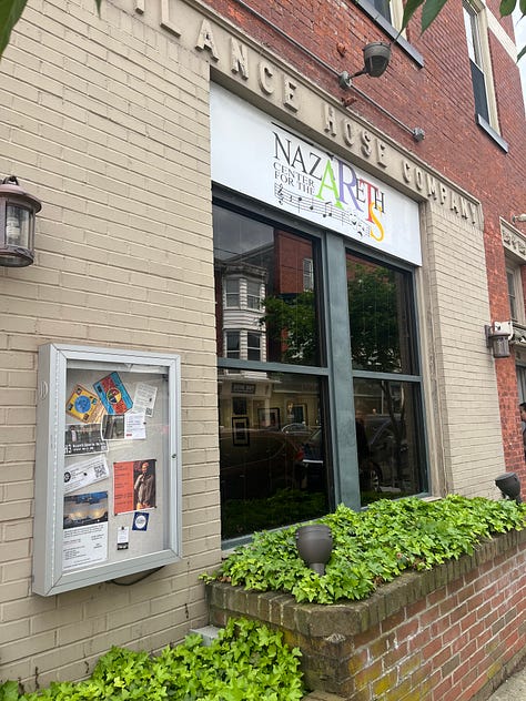 Photo of the front of the arts center. Two more photographs each featuring two photographs in the exhibit. The bottom photo in each column was shot by Joan Zachary. Both have architectural themes.