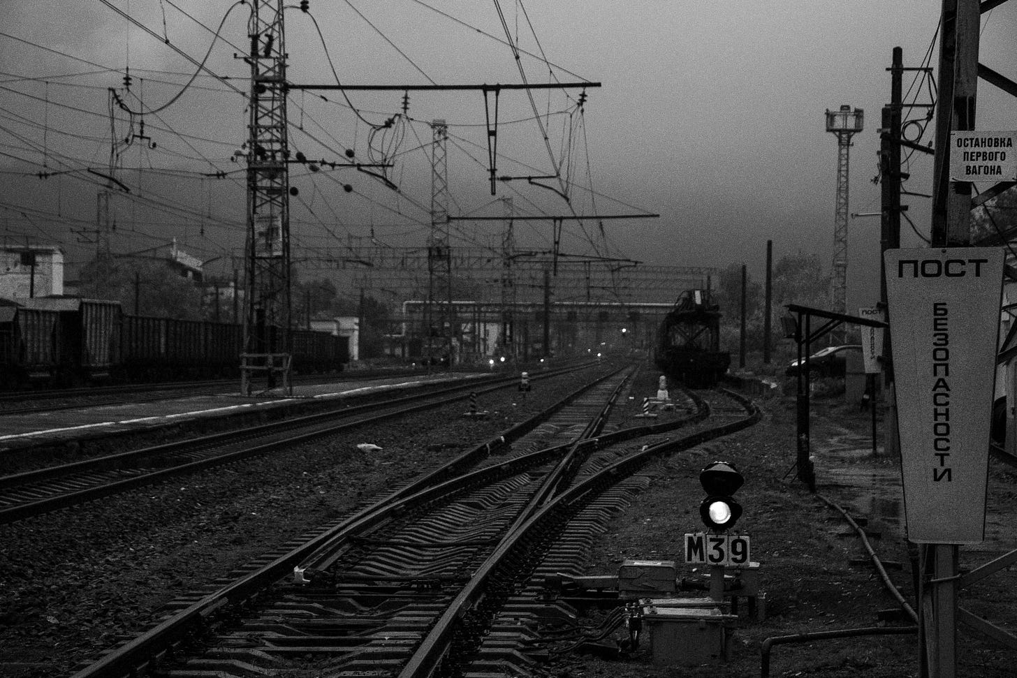 A train track with a green light on it A train track with a green light on it