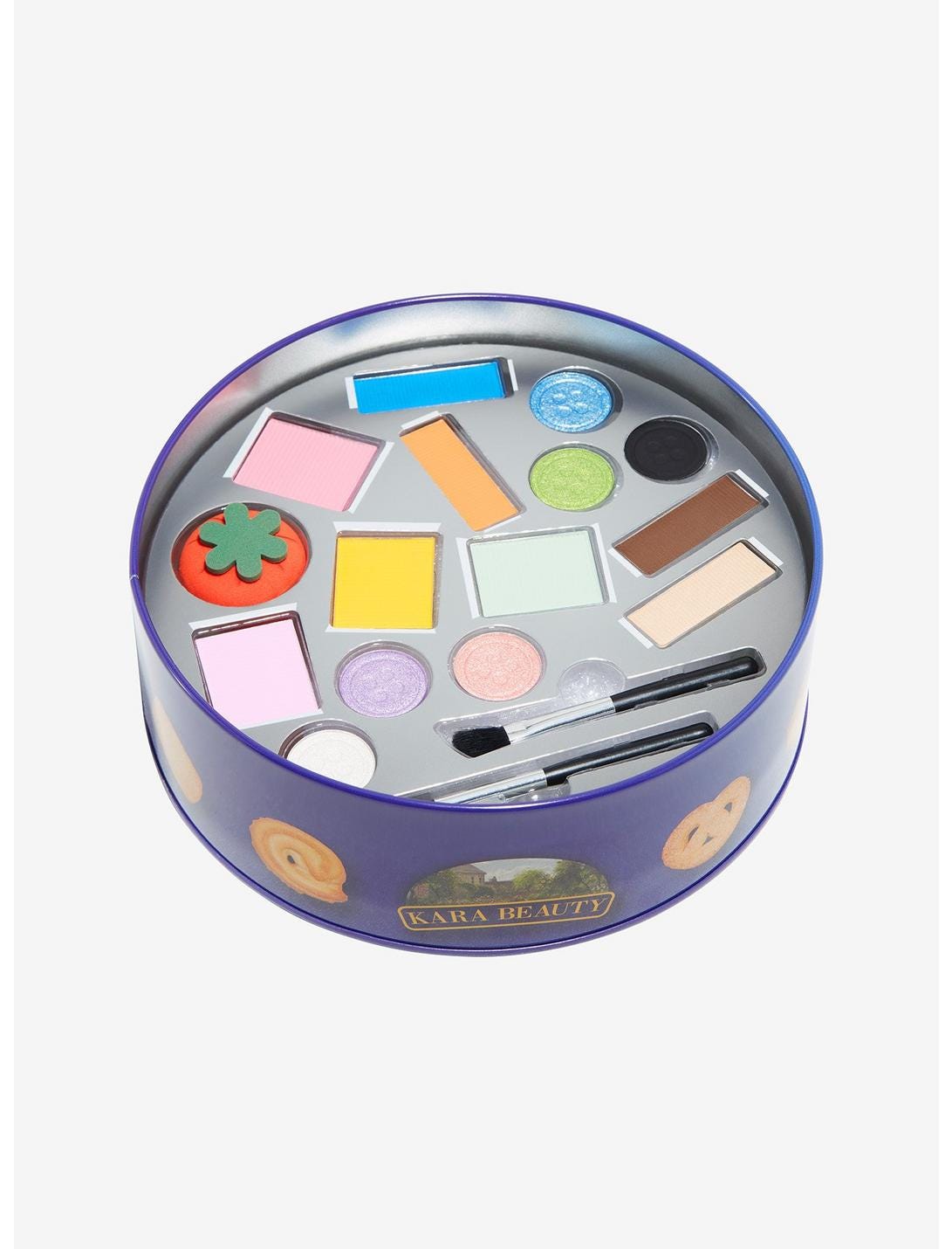  the same tin as above but open, showing it doesn’t contain cookies or sewing supplies but an eyeshadow palette where the eyeshadow is in the shape of spools of thread, a tomato pin cushion, and other sewing supplies