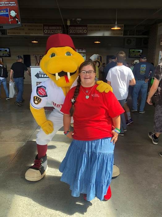 A person posing with a yellow snake mascot

AI-generated content may be incorrect.