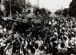 Crowd cheering soldiers on tank] | International Center of Photography