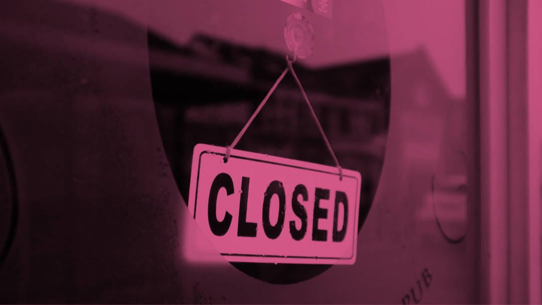 A closed sign hanging on the door of a pub.