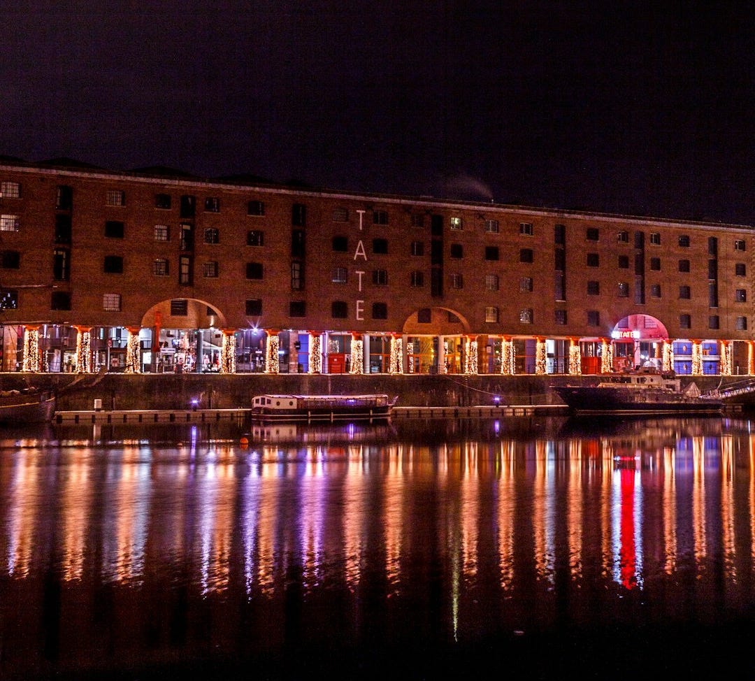 a large building is lit up at night a large building is lit up at night