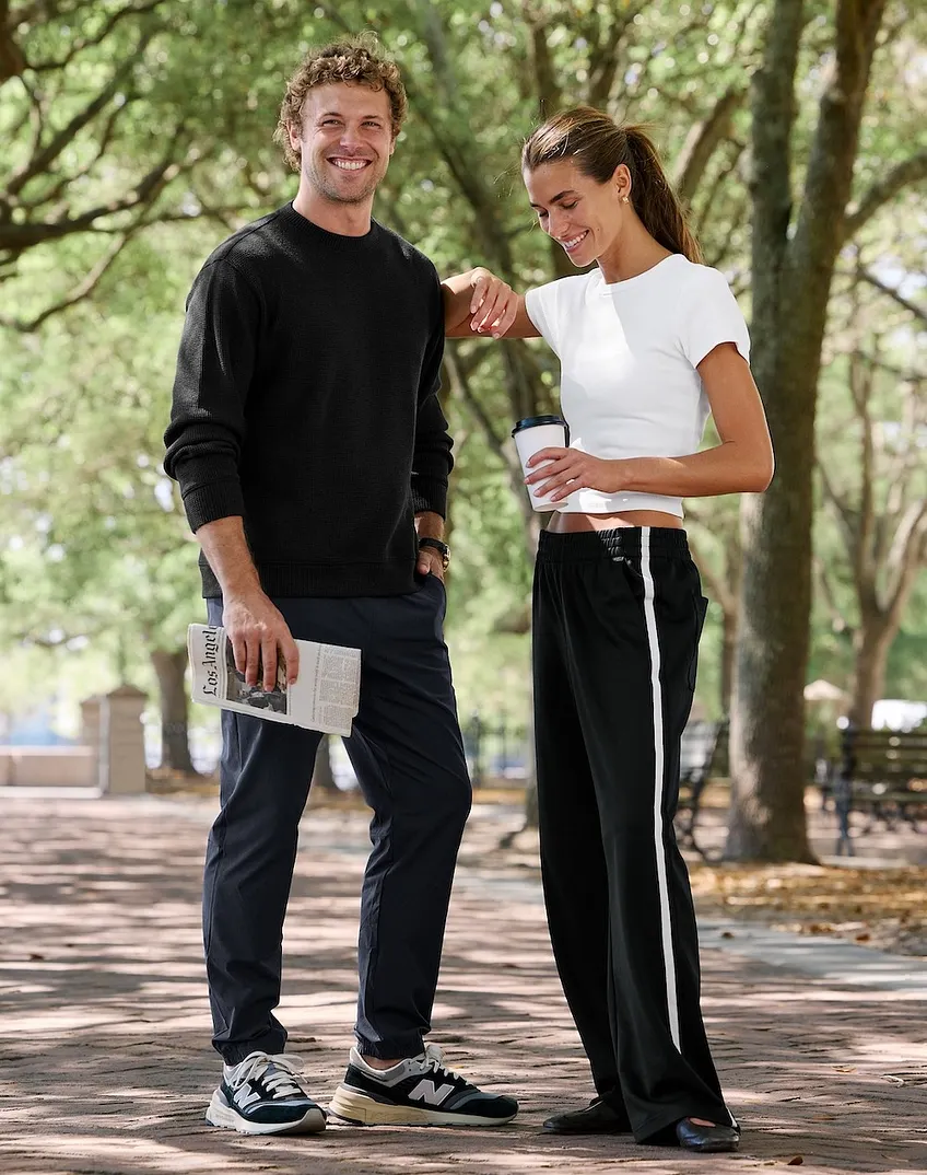 A man and a woman standing in a park