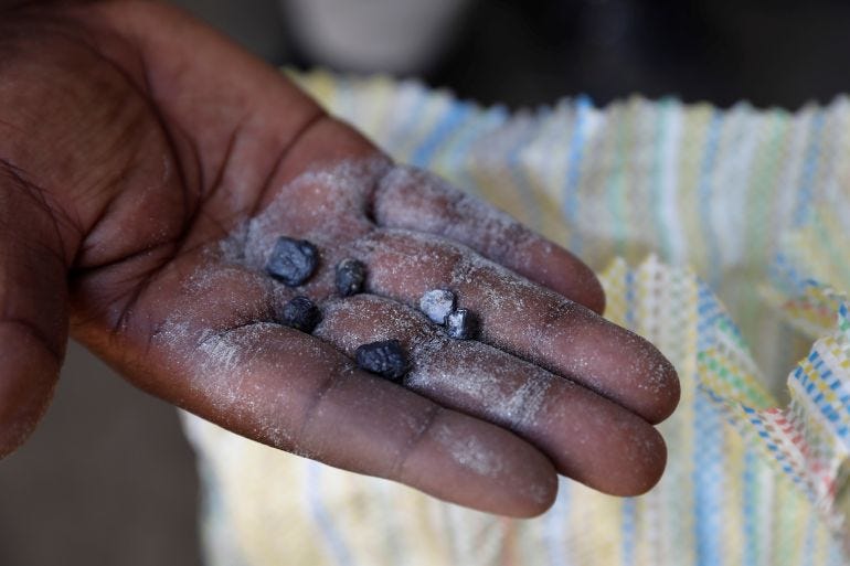 A man displays coltan rocks at the SMB mine near the town of Rubaya in the Eastern Democratic Republic of Congo