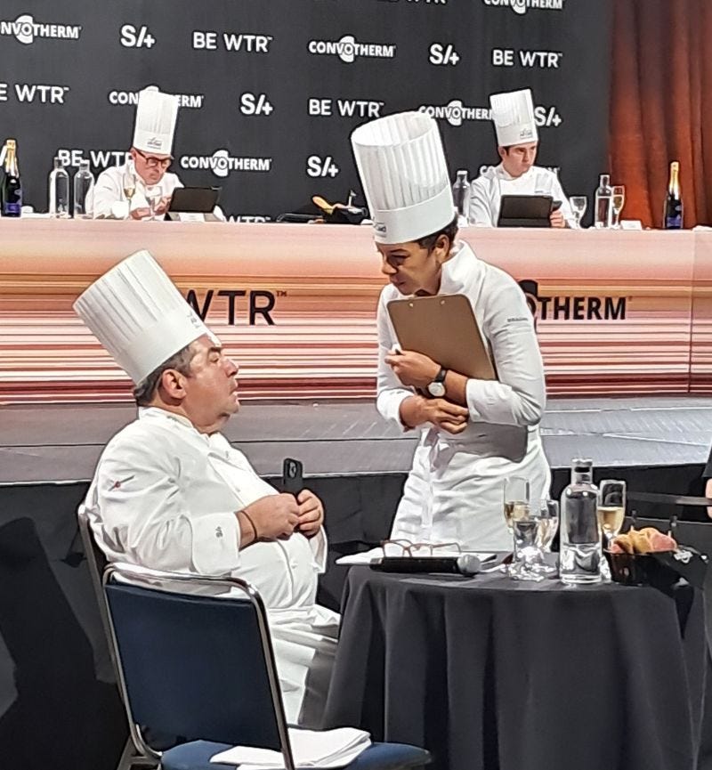 Chef Nina Compton, Compere Lapin, speaking with Chef Emeril Lagasse