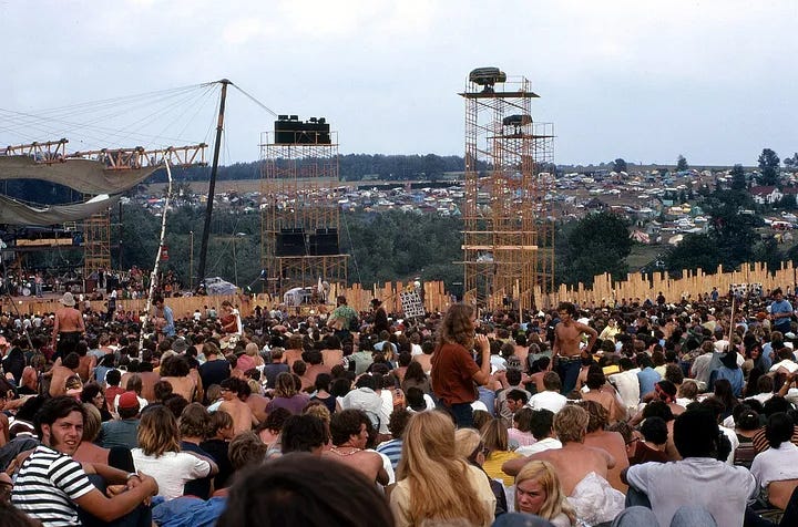 A crowd gathered outside a stage at Woodstock.