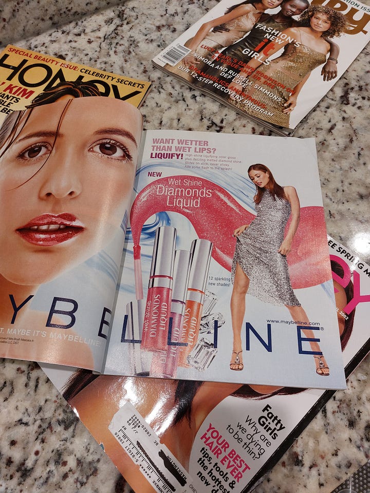 Image one is an ad wit Beyonce smiling, the next is a two page spread for Baby Phat with a woman with long dark hair wearing a denim mini skirt and pink tank. The next image is an ad for Maybelline Diamonds Liquid lip gloss in the colors, pink, mauve, and orange in front of a woman wearing a silver sequined dress. The last image is a series of purses for sale that the magazine is showing off to readers in various colors. mostly deep purple and mauve tones.