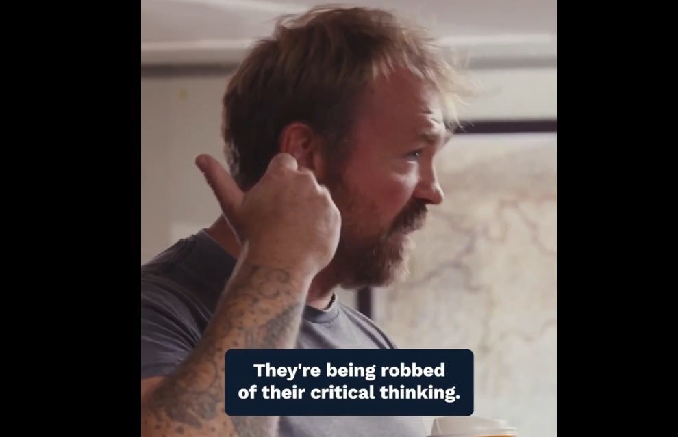 Screenshot of Graham Platner video. Speaking to a northern Maine audience in an American Legion hall, Platner, wearing a grey T-shirt that shows off the tattoos on his arms and holding a cup of Circle K coffee, gestures behind him with a thumb as he speaks. Embedded caption: 'They're being robbed of their critical thinking.' Screenshot of Graham Platner video. Speaking to a northern Maine audience in an American Legion hall, Platner, wearing a grey T-shirt that shows off the tattoos on his arms and holding a cup of Circle K coffee, gestures behind him with a thumb as he speaks. Embedded caption: 'They're being robbed of their critical thinking.'
