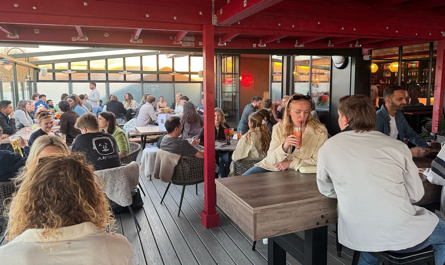 May be an image of 5 people, table, drink and crowd