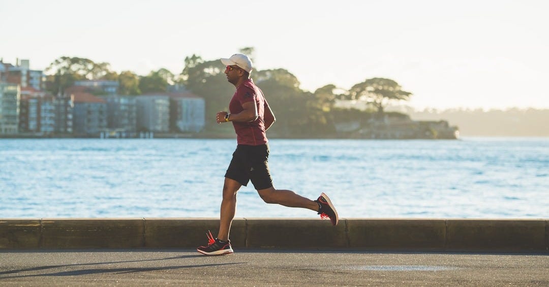 man running near sea during daytime